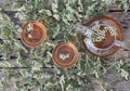 Medicinal herbs.Yarrow herbal tea in a glass teapot with a cup of honey on a wooden natural background