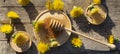 Medicinal honey dandelion with spoon on wooden table Royalty Free Stock Photo