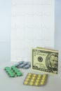 Medicinal pills, dollars on the background of the cardiogram Royalty Free Stock Photo