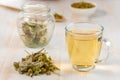 Tea in glass cup with dried herb. Royalty Free Stock Photo