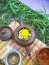 medicinal tea in glass cup with herb in bowl