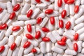 Medicine background from bunch white and red pills in capsule macro Royalty Free Stock Photo