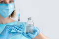 Medicine bottle and syringe for injection in nurse hand. Medical glass vial for vaccination. Science equipment, liquid drug or Royalty Free Stock Photo