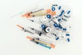 Medicine bottles, ampules and syringes on white background with copy space for text, treatment medication concept closeup