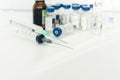 Medicine bottles, ampules and syringes on white background with copy space for text, treatment medication concept closeup