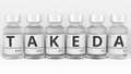 Medicine vials compose TAKEDA pharmaceutical company name. Editorial conceptual 3d rendering