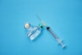 Medicine bottles glass and syringe injection needle on blue background - Medication drug bottle equipment medical tool for nurse