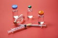 Medicine bottles glass for syringe injection needle on red background - Medication drug bottle equipment medical tool for nurse or Royalty Free Stock Photo