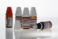 Medicine bottles with homeopathic beads in various dosages and active ingredients. The bottles have red and white caps and are iso Royalty Free Stock Photo