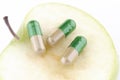 MEDICINE CAPSULES ON TOP OF GREEN APPLE Royalty Free Stock Photo