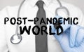 Medicine concept. Doctor writes the word post pandemic world . Image of a hand holding a marker isolated on a white background Royalty Free Stock Photo