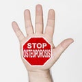 On the palm of the hand there is a stop sign with the inscription - STOP OSTEOPOROSIS. Isolated on white background