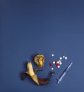 Medicine concept with rotten banana, tainted apple, tablets and syringe. Genetically modified fruit on classic blue background