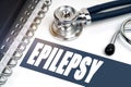 On the table are a stethoscope and a notebook, next to the inscription - EPILEPSY Royalty Free Stock Photo