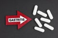 Tablets are on a black background. They are indicated by an arrow on which it is written - GASTRITIS