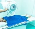 Medicine concept ,Technician Doctor male radiologist with colleague setting up machine to take female patient in x-ray room Royalty Free Stock Photo