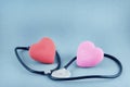 medicine concept. two red hearts entwined with a stethoscope. Royalty Free Stock Photo