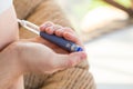 A diabetic patient using insulin pen for making an insulin injection at home. Young man control sugar diabetes. Diabetic lifestyle Royalty Free Stock Photo