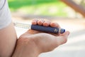 A diabetic patient using insulin pen for making an insulin injection at home. Young man control sugar diabetes. Diabetic lifestyle Royalty Free Stock Photo