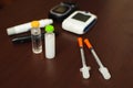 Medicine, diabetes and health care concept - close up of blood sugar test stripe, glucometer, insulin pen and other Royalty Free Stock Photo