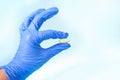 Medicine doctor in a blue latex gloves holding a capsule pill