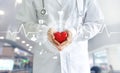 Medicine doctor holding red heart shape in hand and icon medical Royalty Free Stock Photo