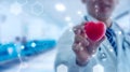 Medicine doctor holding red heart shape in hand with medical Royalty Free Stock Photo