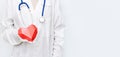 Medicine doctor woman in white coat with stethoscope holds red heart. Healthcare and medical concept Royalty Free Stock Photo