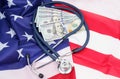 Stethoscope and dollars on the USA flag
