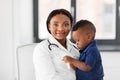 Doctor or pediatrician with baby patient at clinic Royalty Free Stock Photo