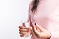 Medicine, health care and people concept - close up of woman taking in pill and another hand holding a glass of clean mineral Royalty Free Stock Photo