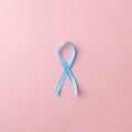 Medicine, health care and symbolics concept - close up of blue prostate cancer awareness ribbon