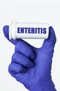 The doctor has a box of pills in his hands, the box says - enteritis