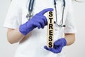 The doctor holds cubes in his hands on which it is written - STRESS Royalty Free Stock Photo