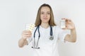 Medicine and health concept. Doctor woman holds pills in hands Royalty Free Stock Photo