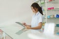 Medicine and health concept, Female pharmacist is checking stock medicine on clipboard in pharmacy Royalty Free Stock Photo