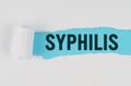 In the middle of a white sheet of paper, a tear is made under which, on a blue background, the inscription - SYPHILIS