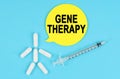 Syringe, human figure made of pills and paper sticker with the inscription - GENE THERAPY Royalty Free Stock Photo