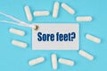 There is a label on the table among the pills that says - Sore feet