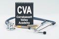 On a white background lies a stethoscope, a pen and a black notebook with the inscription - CVA