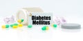 On a white reflective background, there are pills and a jar of drugs with a tag that says - Diabetes Mellitus Royalty Free Stock Photo