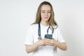 Medicine and health concept. Young woman doctor message in mobile phone