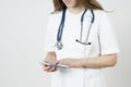 Medicine and health concept. Young woman doctor message in mobile phone