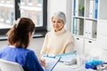 doctor with clipboard and senior woman at hospital Royalty Free Stock Photo