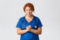 Medicine, healthcare and coronavirus concept. Compassionate and worried female doctor, medical worker clasp hands Royalty Free Stock Photo