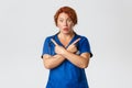 Medicine, healthcare and coronavirus concept. Confused and startled middle-aged redhead female doctor pointing sideways