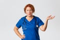 Medicine, healthcare and coronavirus concept. Frustrated and annoyed redhead female medical worker, doctor looking Royalty Free Stock Photo