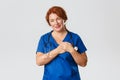 Medicine, healthcare and coronavirus concept. Touched and sympathetic redhead nurse, middle-aged doctor or physician in