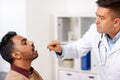 Doctor examining patient throat at clinic Royalty Free Stock Photo