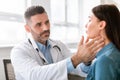 Medicine, healthcare and medical check up concept. Male doctor checking patient& x27;s tonsils at hospital Royalty Free Stock Photo